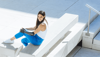 Girl With Bionic Prosthesis Sitting on Bench - The Future of Bionic Prosthesis